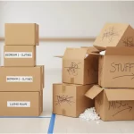 Boxes are neatly labeled with room names and contents, while a messy pile of boxes is haphazardly labeled with "stuff" and "misc."
